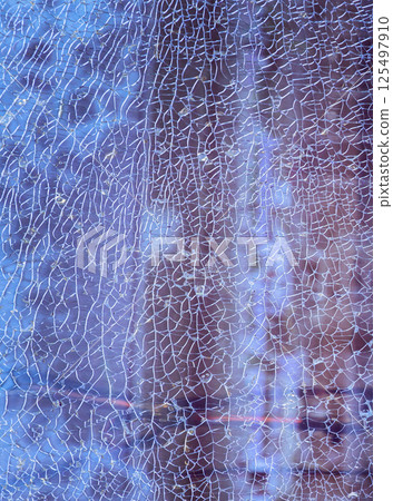 Texture of cracked broken glass cracked by impact. 125497910
