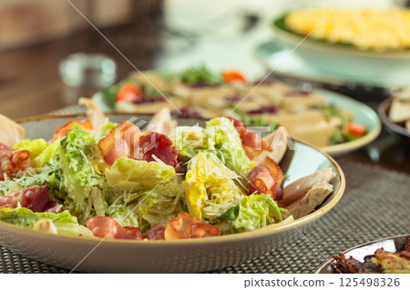 Salad with grilled bacon, hard cheese, tomato, and croutons. Salad with grilled bacon, hard cheese, tomato, and croutons. 125498326
