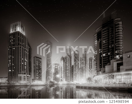 Skyscrapers and bridge over water, black and white style, city background, Dubai Marina bay UAE 125498594