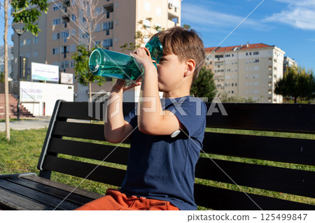 Child with diabetes hydrating outdoors on a sunny day Child with diabetes hydrating outdoors on a sunny day 125499847