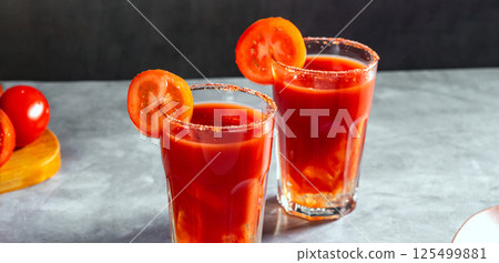 Two refreshing vegetable cocktails. Red cocktail. Tomato juice served in glass with tomato slice. Image for menu, bars, restaurants Two refreshing vegetable cocktails. Red cocktail. Tomato juice served in glass with tomato slice. Image for menu, bars, restaurants 125499881