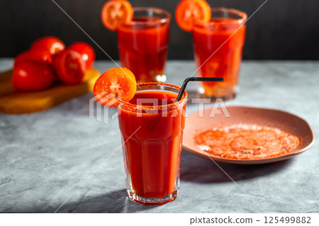 Three refreshing vegetable cocktail. Tomato juice served in glass with tomato slice. Image for menu, bars, restaurants 125499882