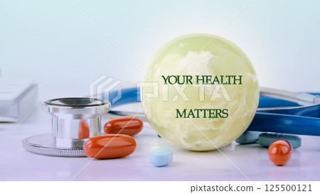In a healthcare setting, stethoscope, pills, and a spherical representation convey the vital message that health is important. Medical analysis symbolizes patient care 125500121