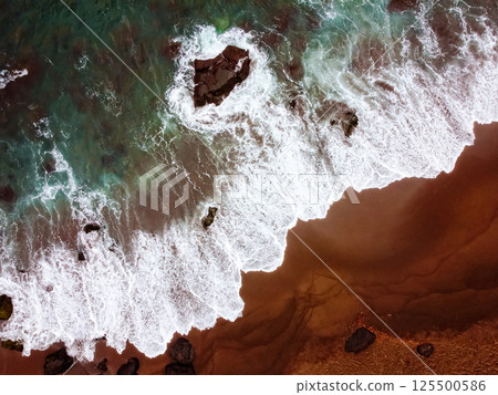 Drone view of Waves on Red Sand Beach 125500586