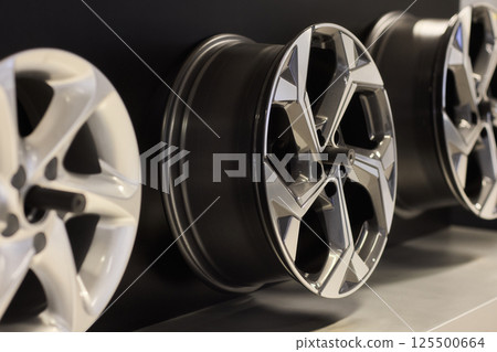 Stylish Automotive Alloy Wheels Display in a modern and chic presentation for car enthusiasts 125500664
