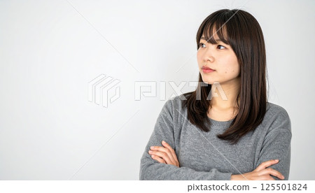 AI image: A young woman thinking with her arms folded 125501824