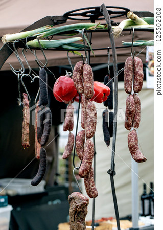 Traditional Sausages Hanging on Metal Rack Traditional Sausages Hanging on Metal Rack 125502108