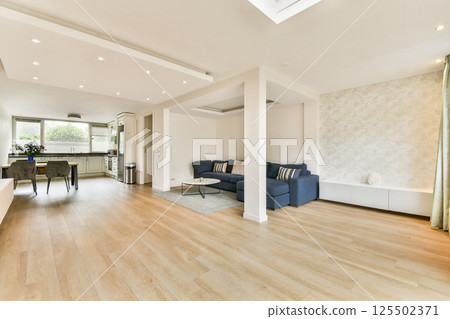 Bright and spacious living room featuring contemporary furniture, wooden flooring, and stylish decor elements, ideal for relaxation and socializing. Bright and spacious living room featuring contemporary furniture, wooden flooring, and stylish decor elements, ideal for relaxation and socializing. 125502371