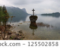 Misty Mondsee Landscape with Crosses and Majestic Mountains 125502858