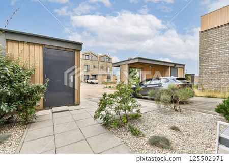 A stunning view of modern buildings surrounded by greenery, featuring a pathway and contemporary design elements. This scene showcases urban planning and nature. A stunning view of modern buildings surrounded by greenery, featuring a pathway and contemporary design elements. This scene showcases urban planning and nature. 125502971