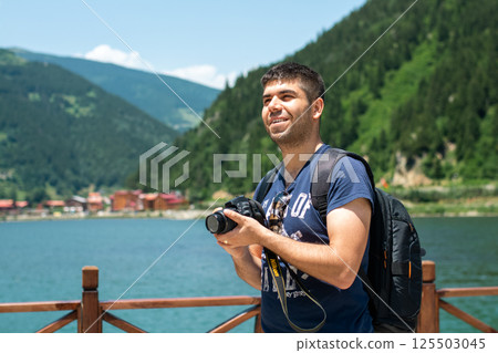 Photographer taking photo of landscape. 125503045