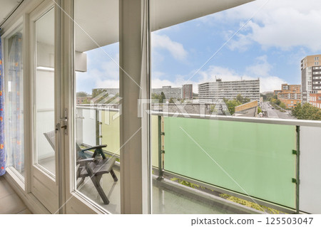 A stylish balcony showcasing a modern cityscape with nearby buildings and a clear sky, perfect for enjoying urban living. A stylish balcony showcasing a modern cityscape with nearby buildings and a clear sky, perfect for enjoying urban living. 125503047