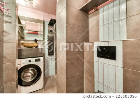 A stylish laundry room featuring sleek designs, neutral tones, and modern appliances, maximizing functionality in a compact space. A stylish laundry room featuring sleek designs, neutral tones, and modern appliances, maximizing functionality in a compact space. 125503056