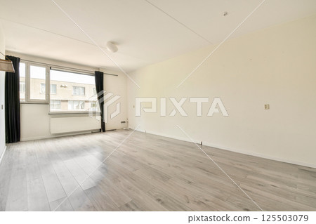 Spacious interior featuring minimal furnishings, large windows for natural light, and neutral tones, providing a calm and serene atmosphere. Spacious interior featuring minimal furnishings, large windows for natural light, and neutral tones, providing a calm and serene atmosphere. 125503079