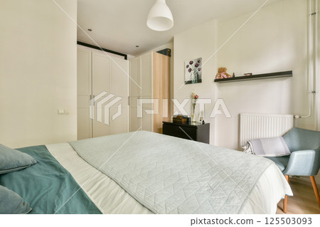 This modern bedroom features a sleek design with a soft color palette, comfortable bedding, and stylish furniture, creating a serene and inviting atmosphere. This modern bedroom features a sleek design with a soft color palette, comfortable bedding, and stylish furniture, creating a serene and inviting atmosphere. 125503093