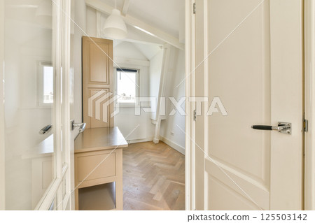 A well-lit, modern interior showcasing elegant design elements with wooden flooring and minimalist decor that creates a serene environment. 125503142