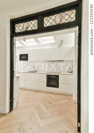 A contemporary kitchen featuring sleek cabinetry, an open layout, and elegant flooring. The space exhibits a modern aesthetic perfect for cooking and entertaining. A contemporary kitchen featuring sleek cabinetry, an open layout, and elegant flooring. The space exhibits a modern aesthetic perfect for cooking and entertaining. 125503436