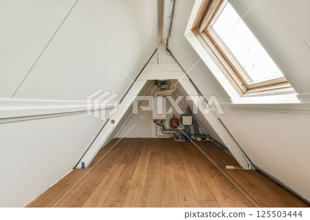 A contemporary interior space showcasing clean lines, wooden flooring, and a skylight. The design emphasizes simplicity and natural light. A contemporary interior space showcasing clean lines, wooden flooring, and a skylight. The design emphasizes simplicity and natural light. 125503444