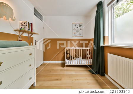 A serene nursery featuring a stylish crib, warm color palette, and playful decor, perfect for a child's restful space. A serene nursery featuring a stylish crib, warm color palette, and playful decor, perfect for a child's restful space. 125503543