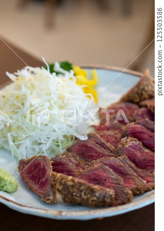 Set of Gyukatsu or beef cutlet served with cabbage. A traditional Japanese food that consists of a deep-fried beef cutlet. 125503586