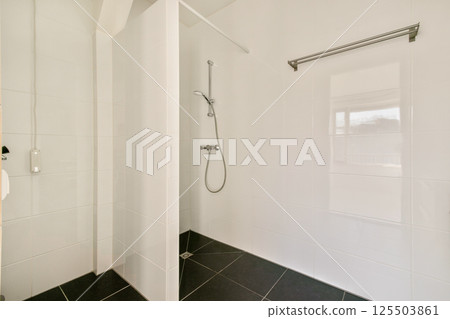 A sleek and contemporary shower area featuring clean lines and a spacious layout, ideal for relaxation and comfort. 125503861