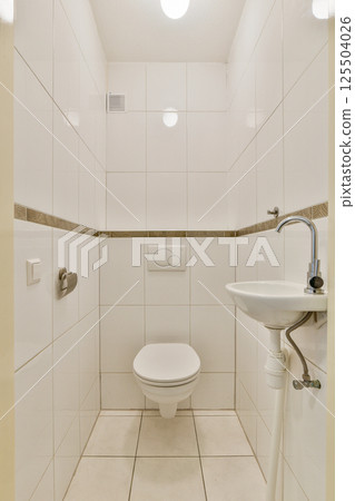 A contemporary bathroom featuring clean lines, white tiles, and minimalistic fixtures, creating a sleek and elegant atmosphere. 125504026