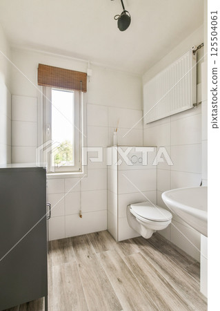 A clean and modern bathroom featuring neutral colors, natural light, and functional fixtures. The design emphasizes simplicity and functionality for a serene atmosphere. A clean and modern bathroom featuring neutral colors, natural light, and functional fixtures. The design emphasizes simplicity and functionality for a serene atmosphere. 125504061