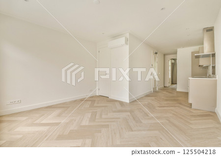 A bright and airy room featuring wooden flooring and clean lines, showcasing a modern minimalist aesthetic perfect for contemporary living. 125504218