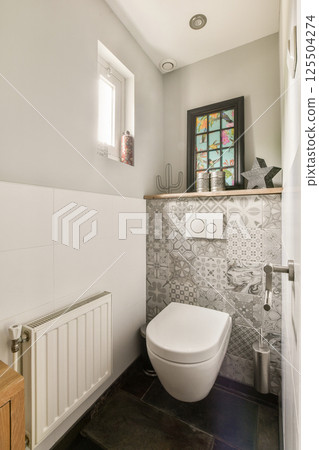 Stylish bathroom showcasing contemporary fixtures, textured walls, and a mix of patterns, creating a serene and functional space. 125504274