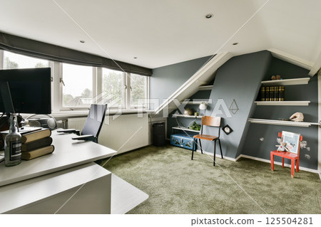 A stylish modern home office featuring a sleek desk, comfortable chair, and ample natural light, creating an inviting workspace that enhances productivity. A stylish modern home office featuring a sleek desk, comfortable chair, and ample natural light, creating an inviting workspace that enhances productivity. 125504281