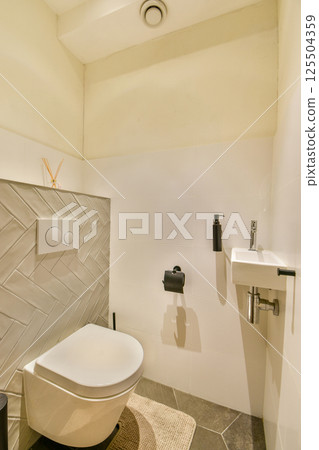 A sleek and contemporary bathroom featuring minimalistic decor, polished surfaces, and efficient fixtures enhancing everyday utility and aesthetics. 125504359