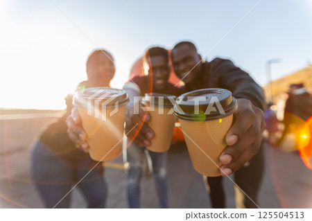 Group of african american friends making coffee toast at sunset. Concept of friendship, celebration, joyful lifestyle moments. 125504513