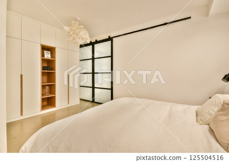 A stylish, serene bedroom featuring sleek furniture, ample storage, and a soft color palette, designed for comfort and relaxation. A stylish, serene bedroom featuring sleek furniture, ample storage, and a soft color palette, designed for comfort and relaxation. 125504516