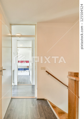 Bright and spacious hallway featuring a wooden staircase and sunlight streaming through large windows, enhancing the contemporary aesthetic. Bright and spacious hallway featuring a wooden staircase and sunlight streaming through large windows, enhancing the contemporary aesthetic. 125504524