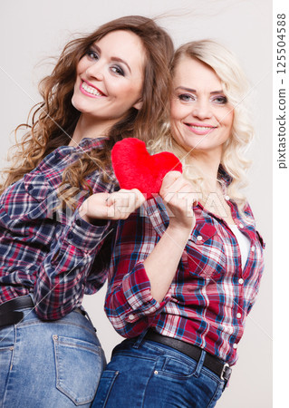 adult daughter and mother with heart love sign 125504588