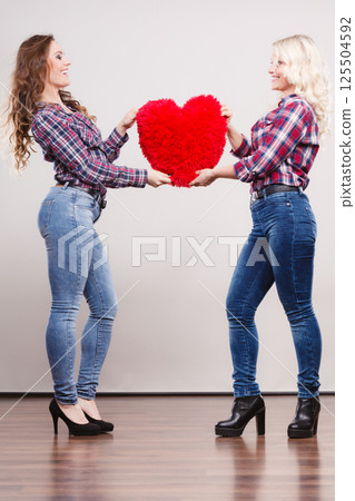 adult daughter and mother with heart love sign 125504592