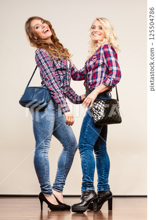 adult daughter and mother with handbags adult daughter and mother with handbags 125504786