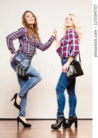adult daughter and mother with handbags adult daughter and mother with handbags 125504787