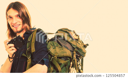 Man tourist backpacker taking photo with camera. Man tourist backpacker taking photo with camera. 125504857