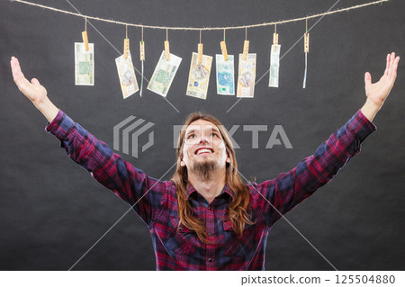 Rich man with laundry of money 125504880