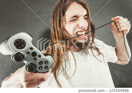 Stressed man playing on pad Stressed man playing on pad 125504886