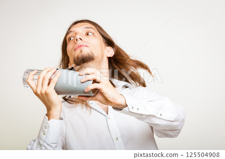 Long haired barman shaking head. 125504908
