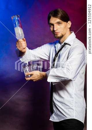 Barman with bottle and glasses. 125504912