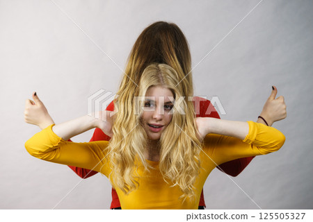 Two girls creating hairdo. Hair ombre color 125505327
