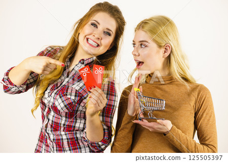 Two women shopping cart with sale 125505397