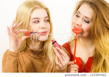 Two women and lip product Two women and lip product 125505401