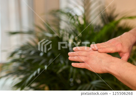 A gloved hand prepares to perform a care procedure safely and professionally in healthcare A gloved hand prepares to perform a care procedure safely and professionally in healthcare 125506268