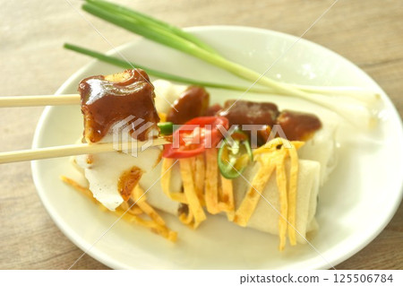 fresh Chinese spring roll made from flour wrapped tofu and pork with bean sprout dressing sweet red gravy sauce on plate fresh Chinese spring roll made from flour wrapped tofu and pork with bean sprout dressing sweet red gravy sauce on plate 125506784