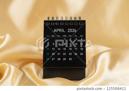 April Desk mini desk calendar black color for 2026 year on gold color silk. 125508421