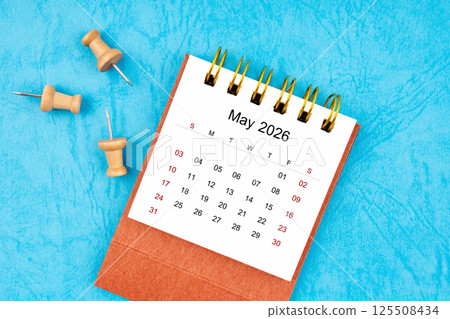 May 2026 mini calendar with wooden thumbtack. 125508434